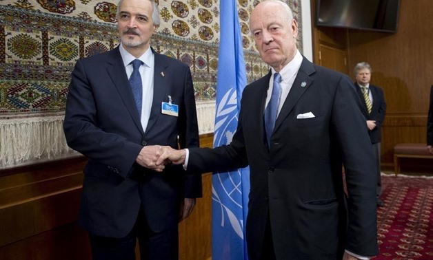 U.N. envoy Staffan de Mistura shakes hands with Syria's Ambassador to the United Nations Bashar al Jaafari (L) during the Syria peace talks in Geneva, Switzerland, January 29, 2016. REUTERS/Jean-Marc Ferre/United Nations/Handout via Reuter