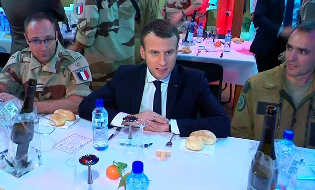 French President Emmanuel Macron, seen in this still image taken from video, sits with French military forces during a visit with troops who participate in the Operation Barkhane in Niamey, Niger, late December 22, 2017 - REUTERS/via Reuters TV
