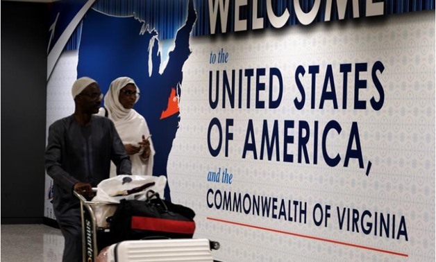 International passengers arrive at Washington Dulles International Airport after the U.S. Supreme Court granted parts of the Trump administration's emergency request to put its travel ban into effect later in the week pending further judicial review, in D