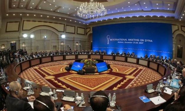 Syrian regime representatives and opposition delegates along with other attendees take part in Syria peace talks in Astana on December 22 -  AFP/Stanislav Filippov
