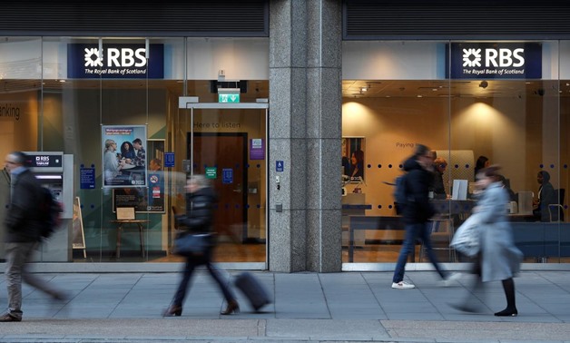 People walk past a branch of the Royal Bank of Scotland in London, Britain December 1, 2017. REUTERS/Peter Nicholls