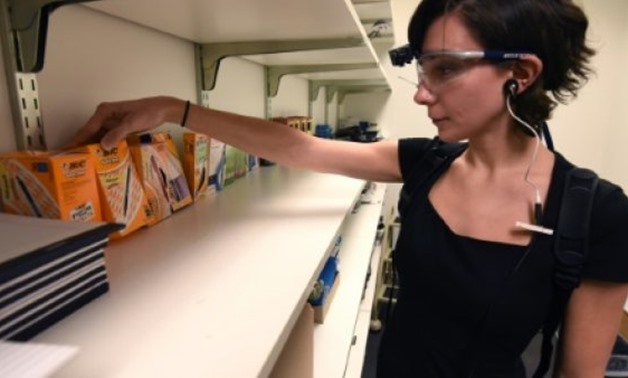 © AFP / by John BIERS | Emily Safian-Demers, of French advertising company Ipsos, demonstrates an eye-tracking gadget used to mine consumers' raw emotions for information
