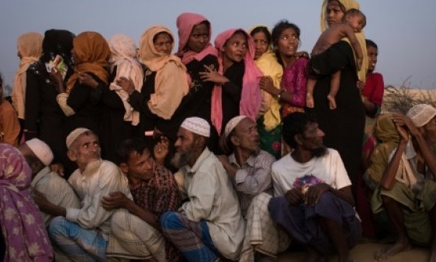 © AFP/File | Rohingya women and men queue at a relief centre at the Kutupalong refugee camp in Cox's Bazar, Bangladesh in this November 28, 2017 photo