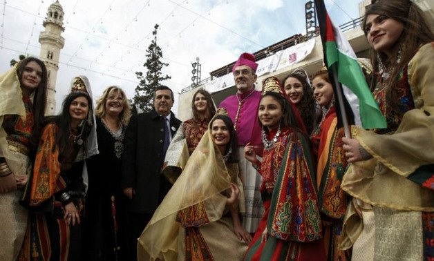 © Musa Al Shaer, AFP | Archbishop Pierbattista Pizzaballa (C), Apostolic Administrator of the Latin Patriarchate of Jerusalem, poses in a group picture with Palestinian women and girls dressed in traditional clothing at the Manger Square outside the Churc