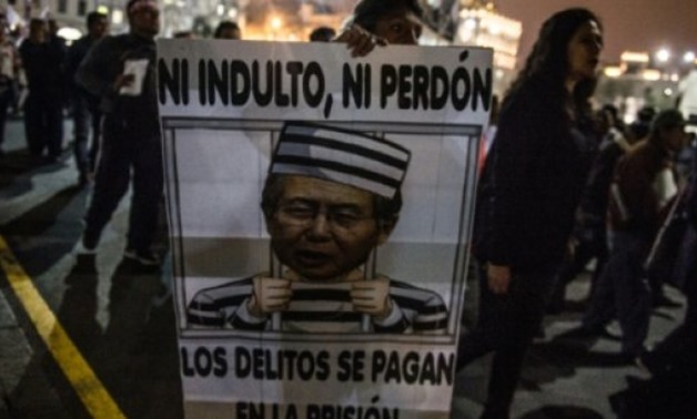 © AFP/File | Activists march against any pardon for Peru's jailed former President Alberto Fujimori in Lima in September 2017
