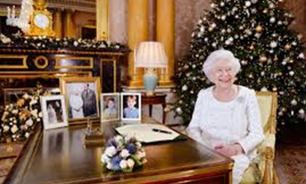 Britain's Queen Elizabeth is seen sitting at a desk in the 1844 Room after recording her Christmas Day broadcast to the Commonwealth, in Buckingham Palace, in this undated photograph received in London, Britain December 24, 2017. REUTERS/John Stillwell/Po