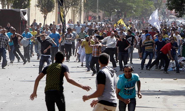 File- Supporters of deposed President Mohamed Mursi and the Muslim Brotherhood clash with anti-Mursi protesters during a march in Shubra street in Cairo October 4, 2013. REUTERS/ Mohamed Abd El Ghany