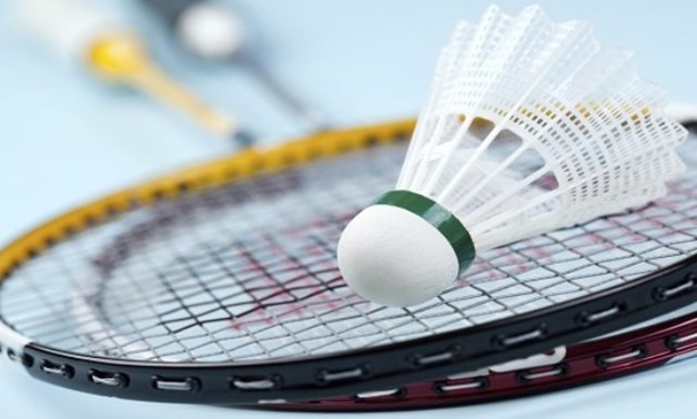 FILE – Badminton rackets and feather