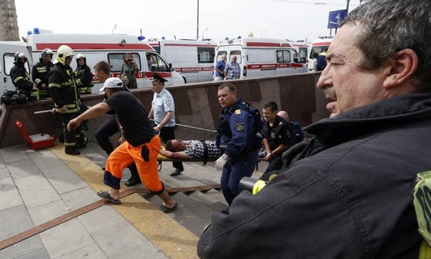 Members of the emergency services carry an injured passenger outside a metro station following an accident on the subway in MoscowThomson - Reuters