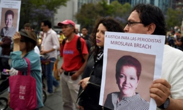A protest in Mexico City in March 2017 against the murder of journalist Miroslava Breach, who had written about the country's drug war before she was gunned down - FILE / AFP