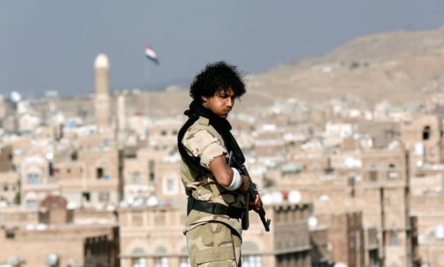 A Houthi militant stands guard on the roof of a building overlooking a rally attended by supporters of the Houthi movement in Sanaa, Yemen March 3, 2017.(REUTERS)

