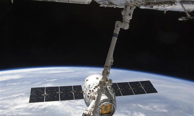 With the Earth in the background, the SpaceX Dragon commercial cargo craft – REUTERS/NASA