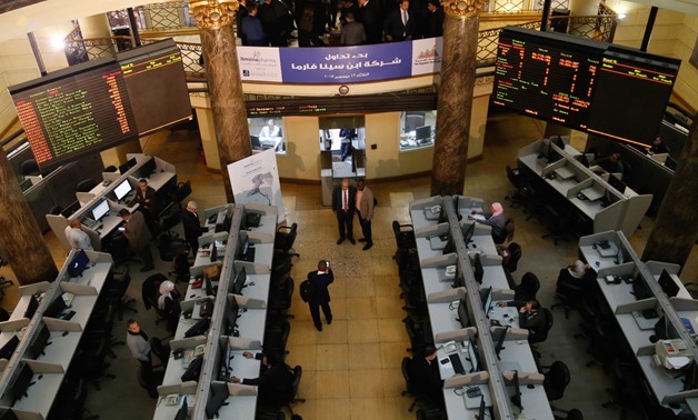 FILE- Employees in the EGX following performance of the trading session
