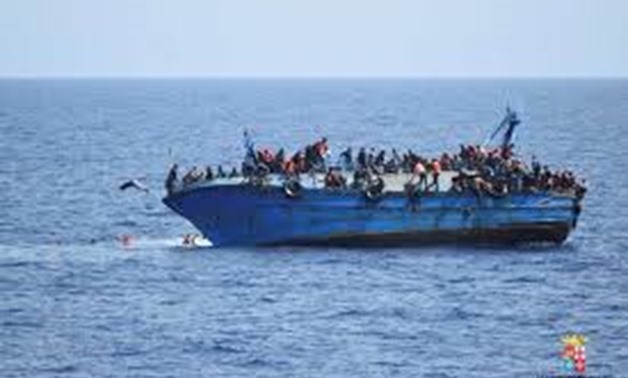 Migrants are seen on a capsizing boat before a rescue operation by Italian navy ships "Bettica" and "Bergamini" (unseen) off the coast of Libya in this handout picture released by the Italian Marina Militare on May 25, 2016. Marina Militare/Handout via RE