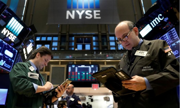 Traders work on the floor of the New York Stock Exchange (NYSE) in New York, U.S., December 13, 2017 -
 REUTERS/Brendan McDermid/File Photo