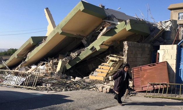 A man walks past a damaged building following an earthquake in Darbandikhan in Sulaimaniya Governorate, Iraq, November 13, 2017. REUTERS/Ako Rasheed