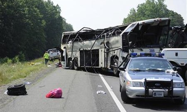 A Virginia State Patrol cruiser sits in front of the aftermath of an early-morning bus crash that killed four people, in the northbound lanes of Interstate 95 in Carmel Church, Virginia, May 31, 2011. REUTERS/Jonathan Erns