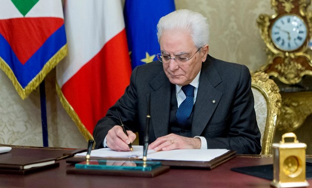 Italian President Sergio Mattarella signs a decree to dissolve parliament at the Quirinale Presidential palace in Rome, Italy, December 28, 2017. Presidential Press Office/Handout via Reuters
