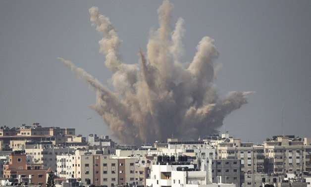 Smoke and sand are seen following what witnesses said was an Israeli air strike in Gaza August 25, 2014. Photo by Reuters
