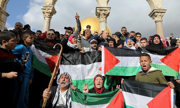 Worshippers hold Palestinian flags as they protest after Friday prayers on the compound known to Muslims as Noble Sanctuary and to Jews as Temple Mount in Jerusalem's Old City, as Palestinians call for a "Day of Rage" in response to President Donald Trump