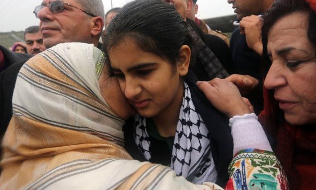 Palestinian 14-year-old schoolgirl Malak al-Khatib is greeted by relatives after her release from an Israeli jail on February 13, 2015, in the West Bank Palestinian village of Tulkarem (AFP Photo/Jaafar Ashtiyeh)