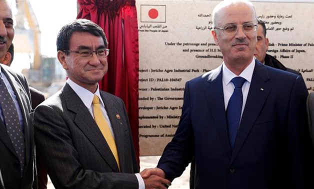 Japanese Foreign Minister Taro Kono (C-L) shakes hands with Palestinian prime minister Rami Hamdallah in the West Bank city of Jericho on December 26, 2017- AFP