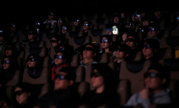 
FILE PHOTO: People wearing 3D glasses watch the movie "The LEGO Batman Movie" at a media event in a movie theatre in Shanghai, China February 28, 2017. REUTERS/Aly Song