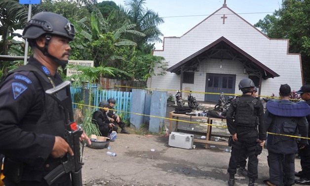 Police stand near the scene of an explosion outside a church in Samarinda, East Kalimantan, Indonesia November 13, 2016 in this photo taken by Antara Foto.