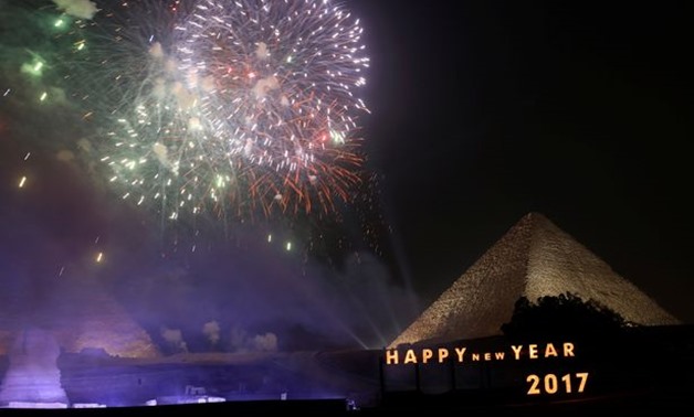 Fireworks explode above the pyramids during New Year's day celebrations on the outskirts of Cairo - REUTERS
