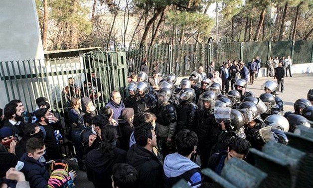 Students scuffle with police at the University of Tehran during a demonstration driven by anger over economic problems in the Iranian capital Tehran on December 30, 2017 - AFP

