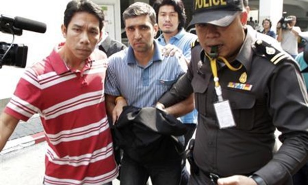 Thai police officers escort Iranian suspect Mohammad Khazaei (C), 42, at the Immigration Bureau in Bangkok February 16, 2012. REUTERS/Chaiwat Subprasom. 