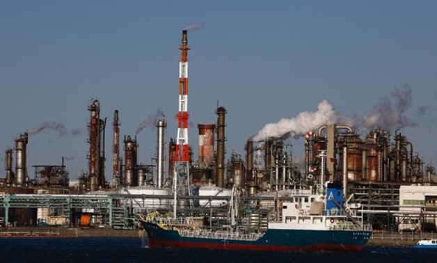 A ship passes a petro-industrial complex in Kawasaki near Tokyo December 18, 2014. REUTERS/Thomas Peter