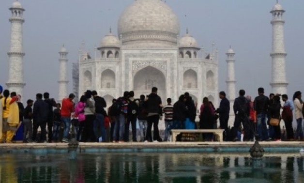 Crowds gather to visit the Taj Mahal: India is to restrict the number of daily visitors - AFP