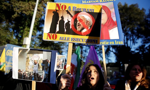 Opponents of Iranian President Hassan Rouhani hold a protest outside the Iranian embassy in Rome, Italy, January 2, 2018. REUTERS/Tony Gentile