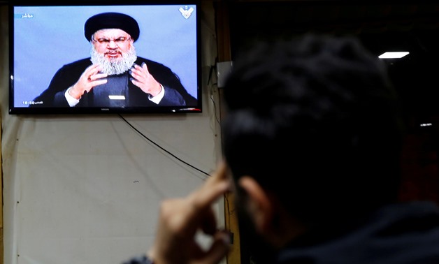 A man watches Lebanon's Hezbollah leader Sayyed Hassan Nasrallah as he speaks on television in Beirut, Lebanon November 20, 2017.REUTERS/ Jamal Saidi/File Photo