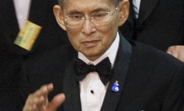 FILE - Thailand's King Bhumibol Adulyadej waves to well-wishers during a concert at Siriraj hospital in Bangkok on September 29, 2010.
