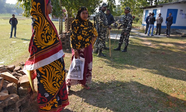 Women stand next to policemen as they wait to check their names on the draft list of the National Register of Citizens (NRC) at an NRC centre in Chandamari village in Goalpara district, in the northeastern state of Assam, India, January 2, 2018. Picture t