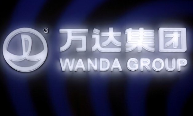 FILE PHOTO: A sign of Dalian Wanda Group in China glows during an event announcing strategic partnership between Wanda Group and FIFA in Beijing, China March 21, 2016. REUTERS/Damir Sagolj/File Photo