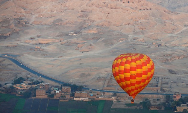 A hot-air balloon flies over the village of al-Qurna, situated over a necropolis of more than 500 pharaonic tombs at the feet of the Theban Mountains, in the city of Luxor- Reuters/Amr Abdallah Dalsh