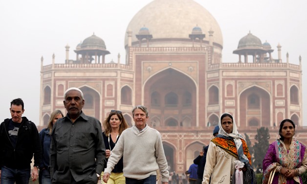 Domestic and foreign tourists walk in front of Humayun's Tomb, one of the tourist destinations in New Delhi, India, January 1, 2018. Picture taken January 1, 2018. REUTERS/Saumya Khandelwal