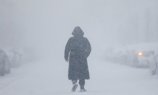 A woman walks down the street during a blizzard in Long Beach, New York, U.S. January 4, 2018. REUTERS/Shannon Stapleton.
