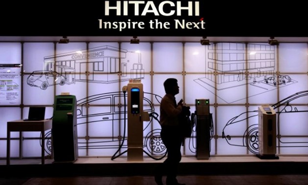 FILE PHOTO: A man walks past Hitachi's booth at CEATEC JAPAN 2012 electronics show in Chiba, east of Tokyo, Japan October 2, 2012. REUTERS/Yuriko Nakao/File Photo