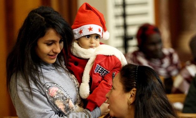  Worshipers chatting during the Christmas mass held at Evangelical Church in Heliopolis on Friday  -  Photo courtesy/ Hassan Mohamed