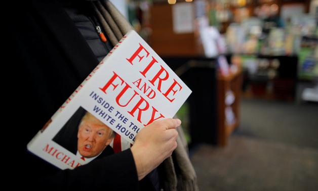 A woman holds a copy of the book "Fire and Fury: Inside the Trump White House" by author Michael Wolff are seen at a local book store in Washington, DC, U.S. January 5, 2018. REUTERS/Carlos Barria