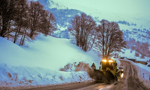 AFP • January 4, 2018. A snowplough clears a road leading to the French Alps ski resort of Les Menuires on
