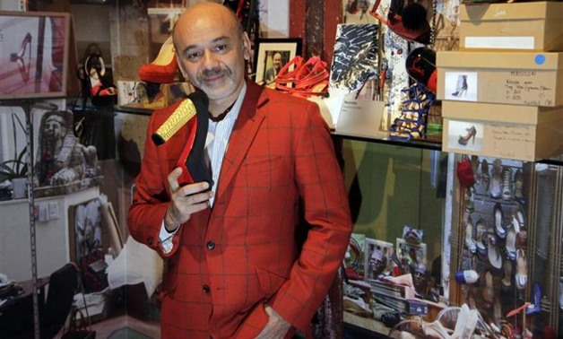 French shoe designer Christian Louboutin poses for photographs during a media viewing of his retrospective exhibition at the Design Museum in London, April 30, 2012 - REUTERS/Stefan Wermuth