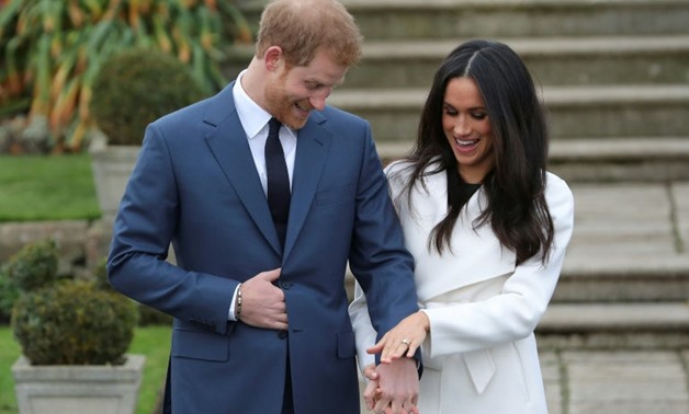 Prince Harry and Meghan Markle show off her engagement ring while posing in the Sunken Garden at Kensington Palace in London - AFP/File / Daniel LEAL-OLIVAS
