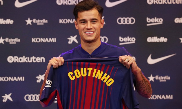 Soccer Football - FC Barcelona - Philippe Coutinho News Conference - Auditorium 1899, Barcelona, Spain - January 8, 2018 FC Barcelona's new signing Philippe Coutinho poses with the club shirt REUTERS/Albert Gea