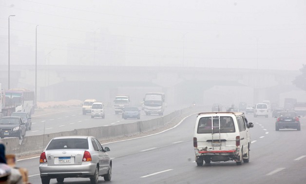 File photo: Cars driving on the foggy ring road in Cairo