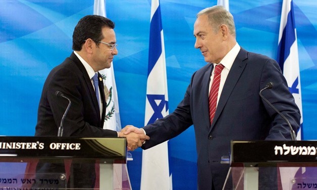 Guatemalan President Jimmy Morales and Israeli Prime Minister Benjamin Netanyahu shake hands during their meeting in Jerusalem as they deliver statements to the media November 29, 2016 – REUTERS/Abir Sultan